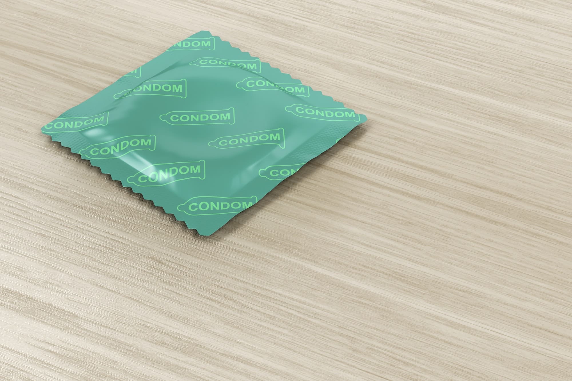 Condom on wood background