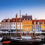 COPENHAGEN, DENMARK - MAY 6, 2018: scenic view of beautiful colorful buildings and boats moored in